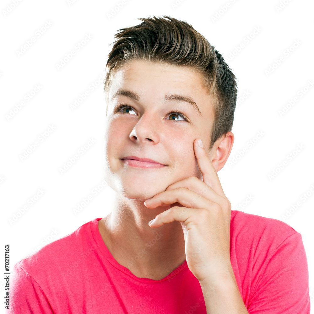 Handsome teen looking at corner isolated.