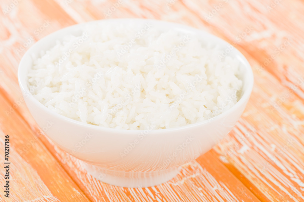 Steamed Rice - Boiled rice in a bowl on an orange background. Steamed Rice - Boiled rice in a bowl on an orange background.