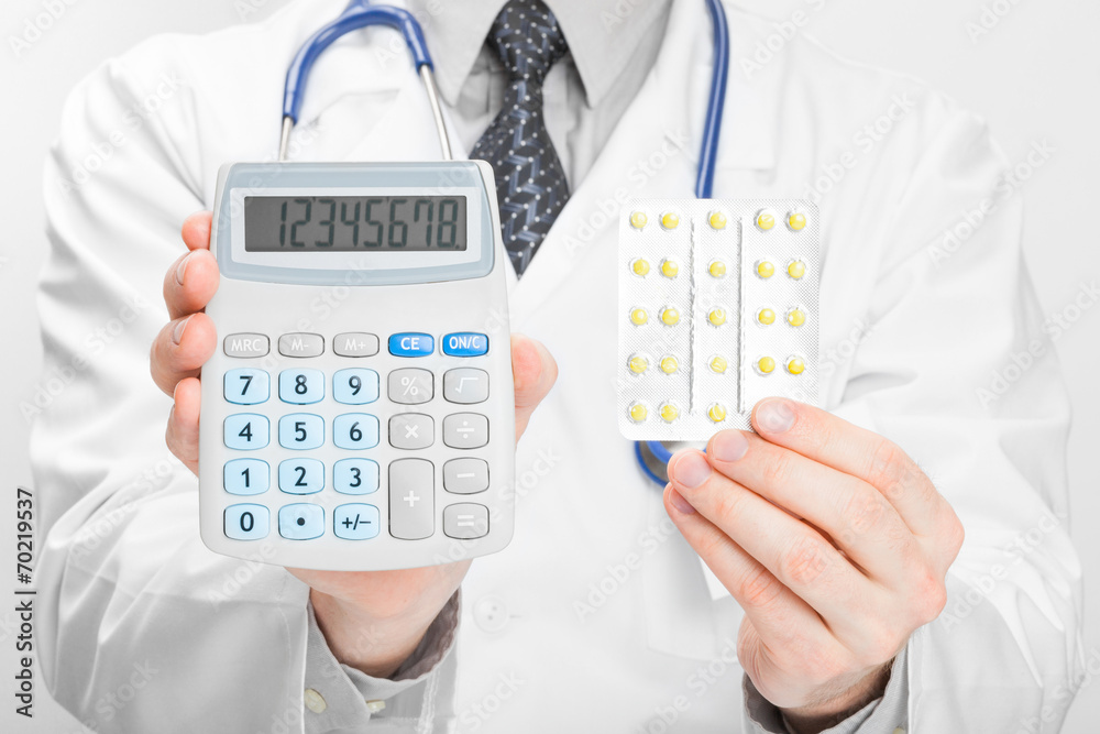 Doctor holdling calculator and pills in his hands Doctor holdling calculator and pills in his hands