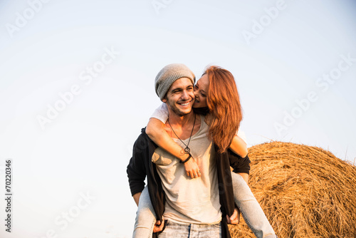 young couple laughing and joking in the countryside photo