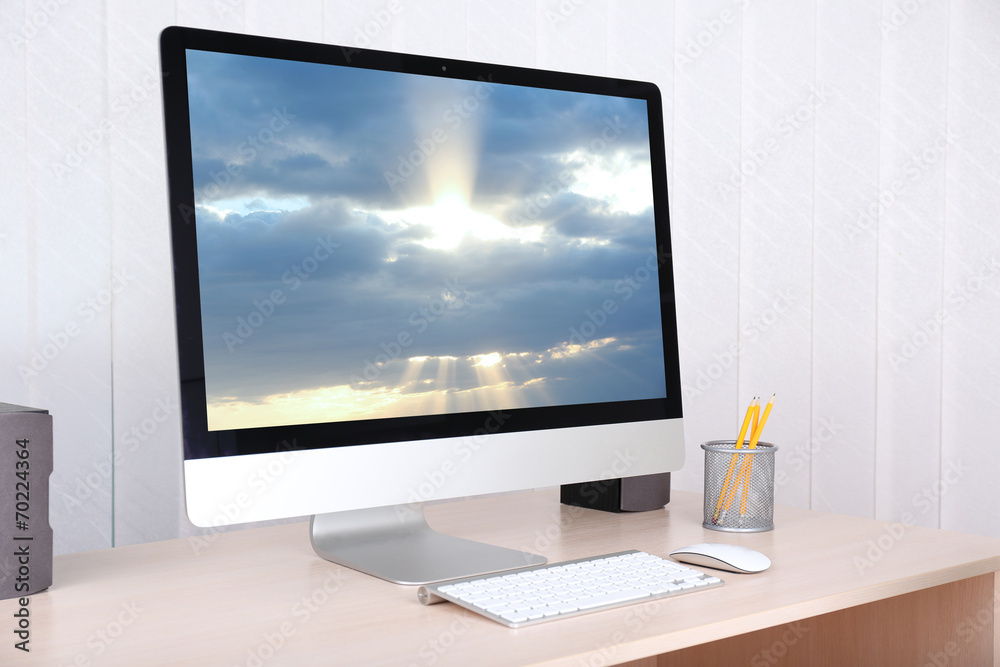 Fototapeta premium Computer with screensaver on table