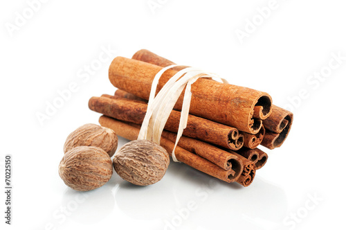 Tied cinnamon sticks and nutmeg over white