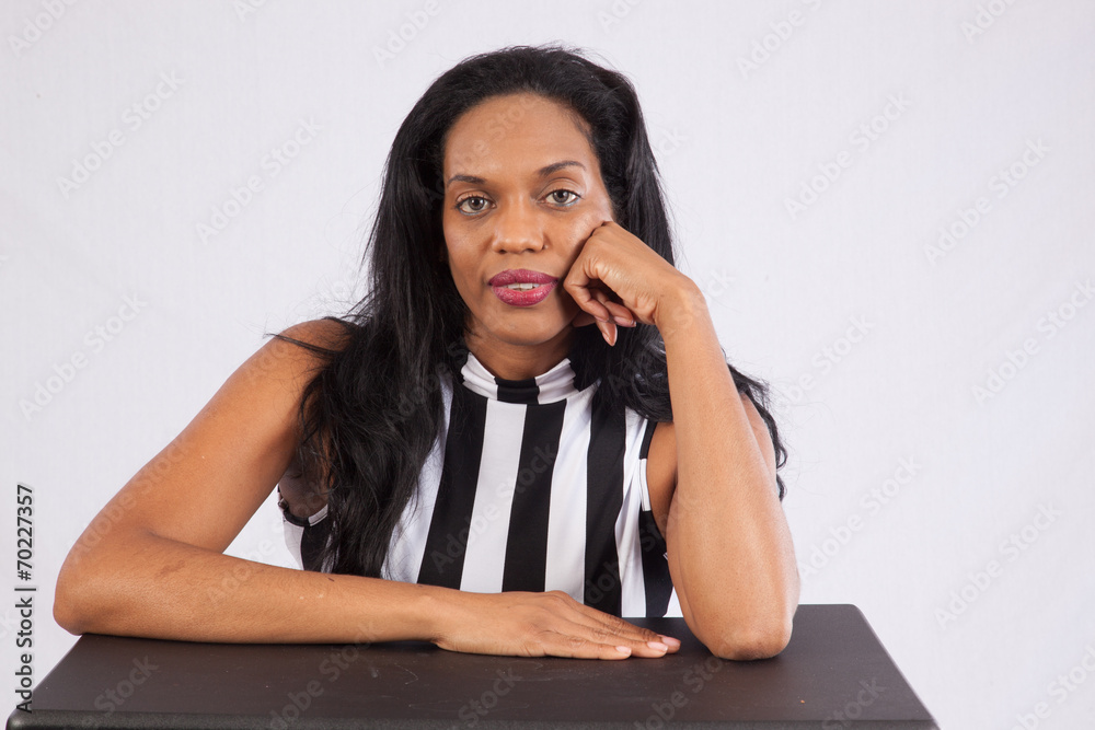 black woman thinking and looking at the camera