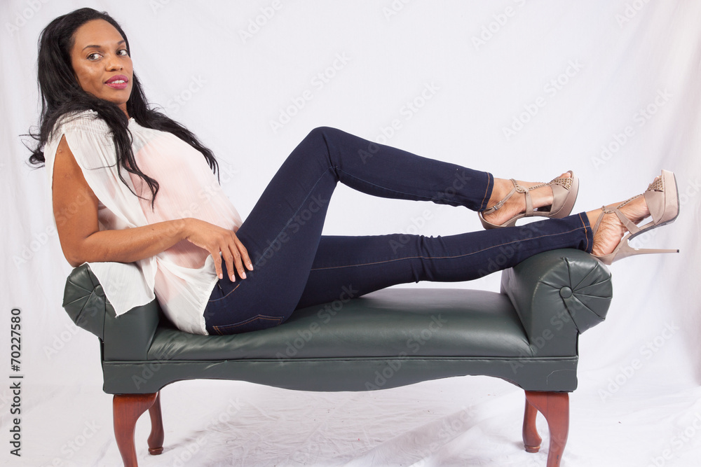 Black woman reclining and smiling at the camera