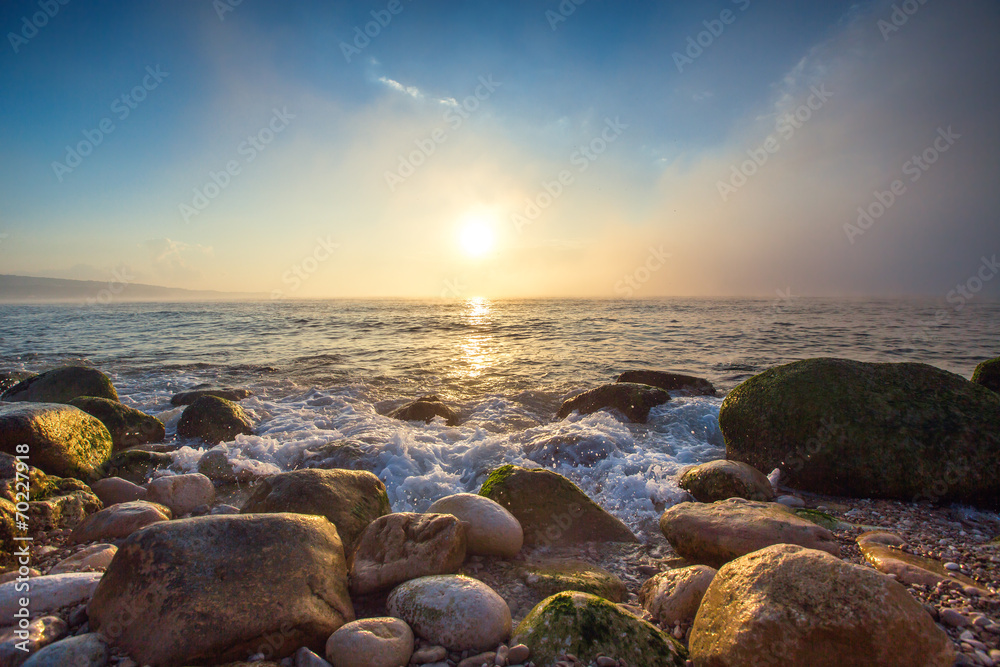 Sunrise over sea and fog