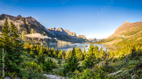 Panoramic landscape view of Glacier NP mountain range and lake