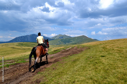 Rodna mountains in Romania - horse with man photo