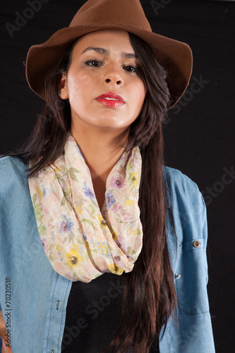 Woman in brown hat and blue jacket, lookinga the viewer photo