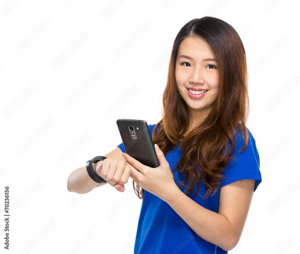 Woman use mobile phone synchronization to wearable watch Woman use mobile phone synchronization to wearable watch