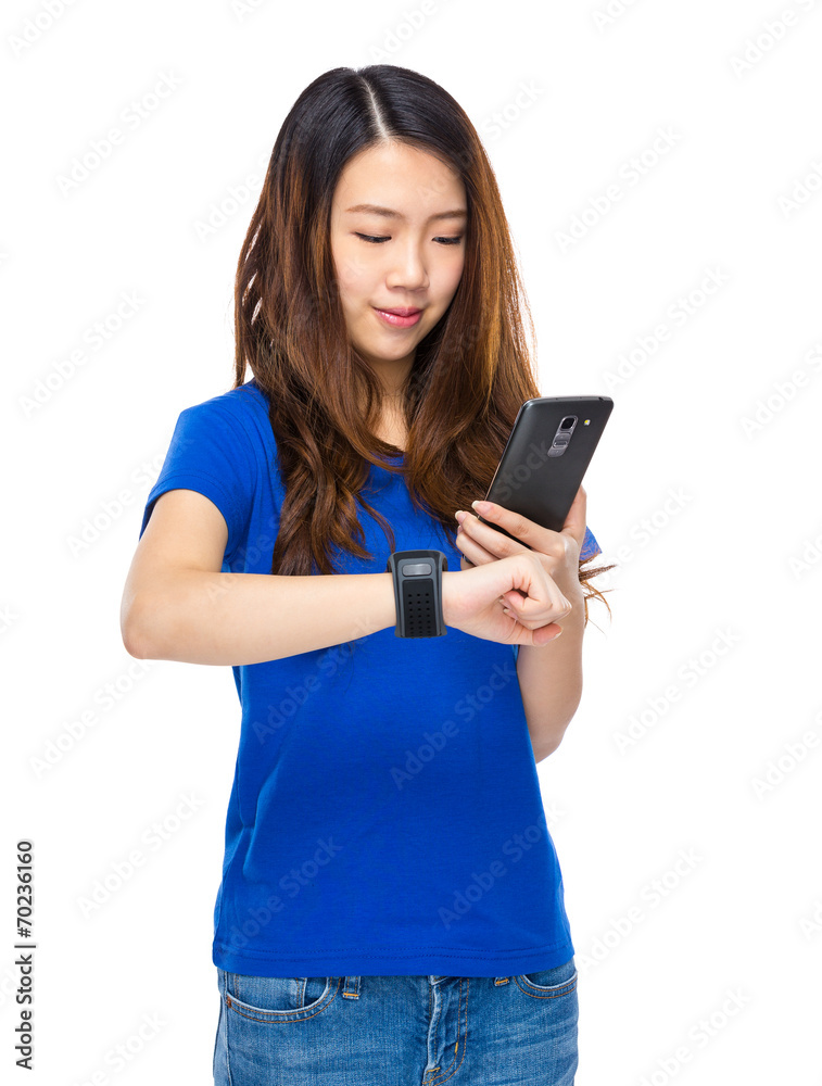 Woman use mobile phone connect to wearable watch Woman use mobile phone connect to wearable watch
