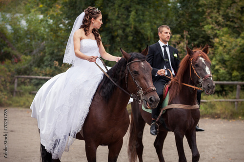 wedding couple on horses © alkiona_25