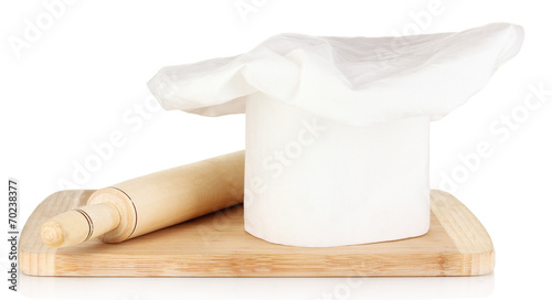 Chef's hat with spoon and battledore isolated on white