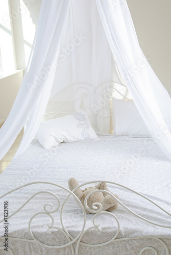 white bed with a baldachin by krausens and soft toy photo