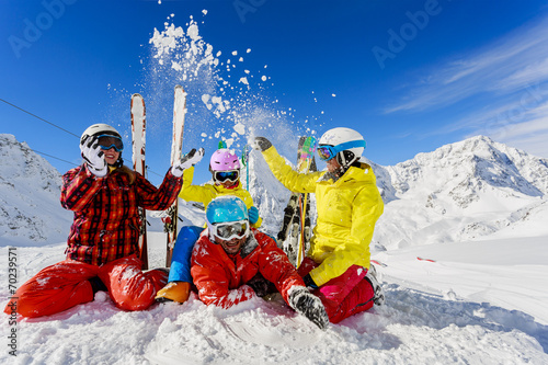 Ski, winter fun - skiers enjoying ski vacation