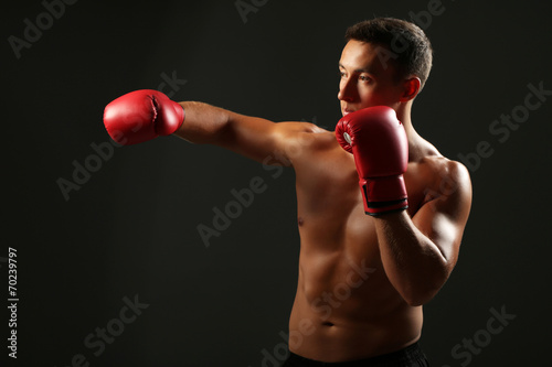 Handsome young muscular sportsman with boxing gloves © Africa Studio
