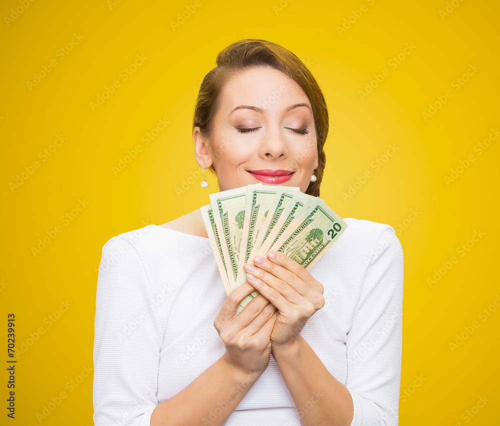 Woman loves money isolated on yellow background Woman loves money isolated on yellow background