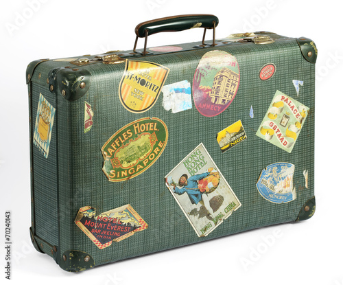 Old vintage suitcase with travel labels photo