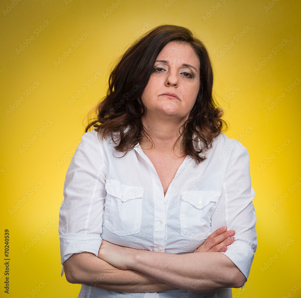 Displeased pissed off angry grumpy woman on yellow background Displeased pissed off angry grumpy woman on yellow background