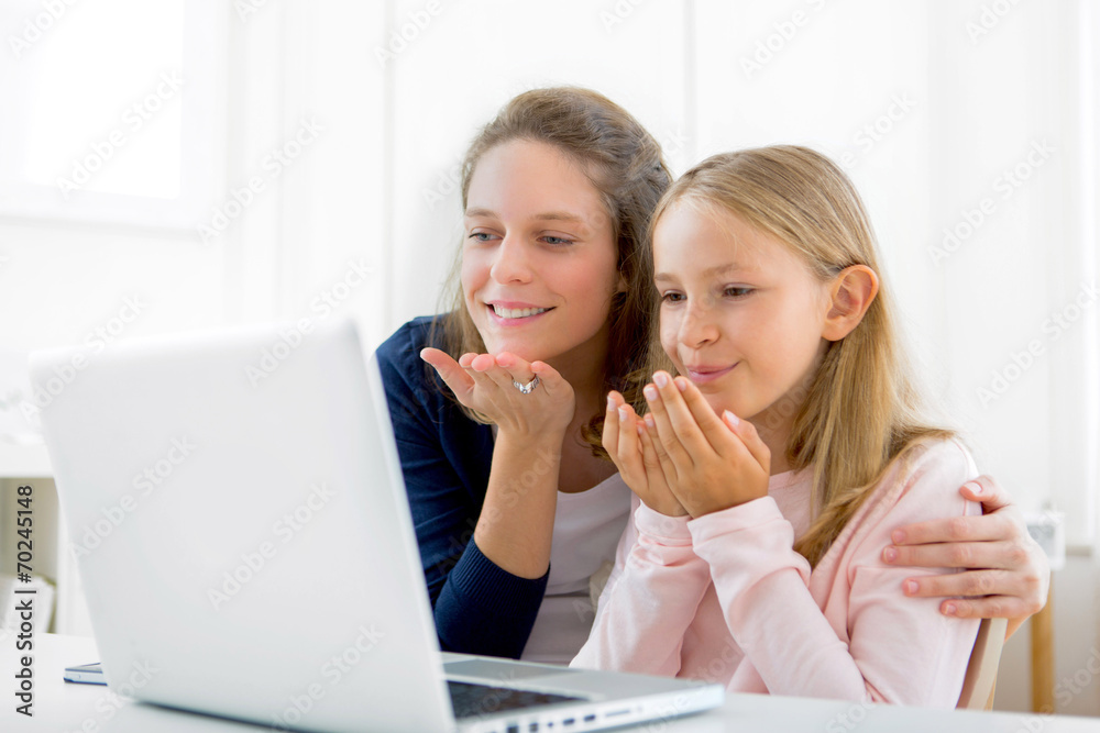 Attractive woman and little sister videocalling Attractive woman and little sister videocalling