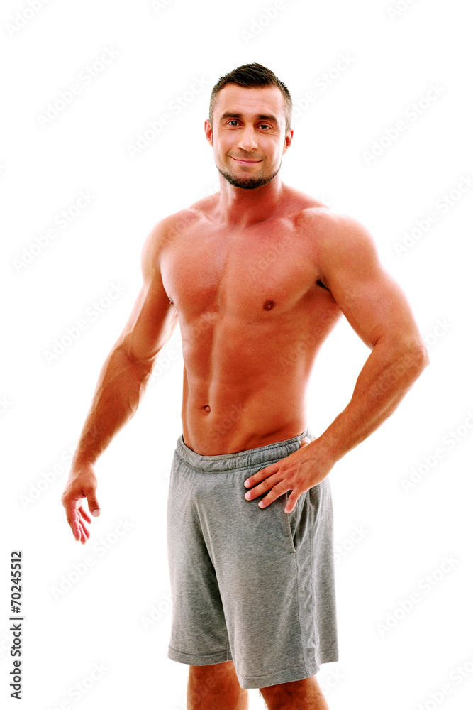 Happy muscular sportsman standing over white background Happy muscular sportsman standing over white background