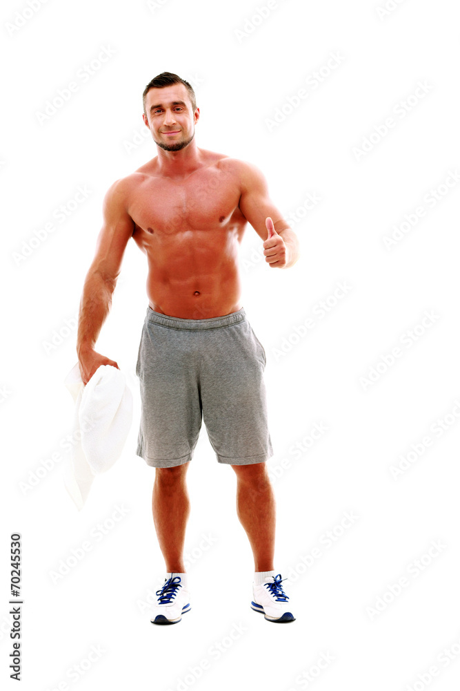 Happy sportsman holding towel and showing thumb up Happy sportsman holding towel and showing thumb up