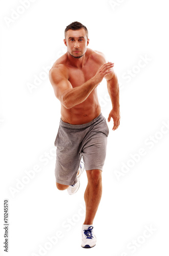 Full length portrait of young man athlete doing running exercise