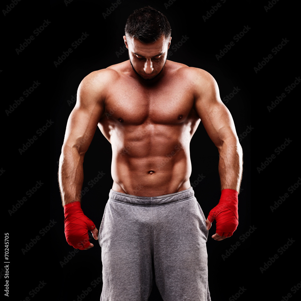 Portrait of a muscular man isolated on a black background Portrait of a muscular man isolated on a black background