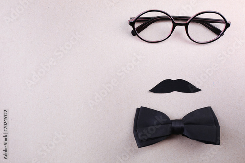 Glasses, mustache and bow tie forming man face