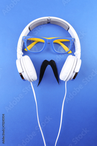 Glasses, mustache and headphone forming man face