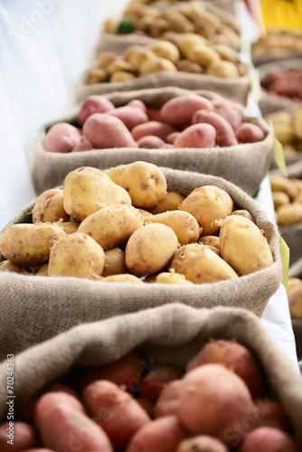 Harvest raw potatoes in burlap sack in market