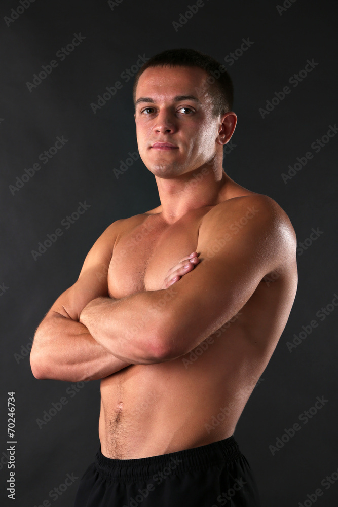 Fototapeta premium Handsome muscle young man on dark background