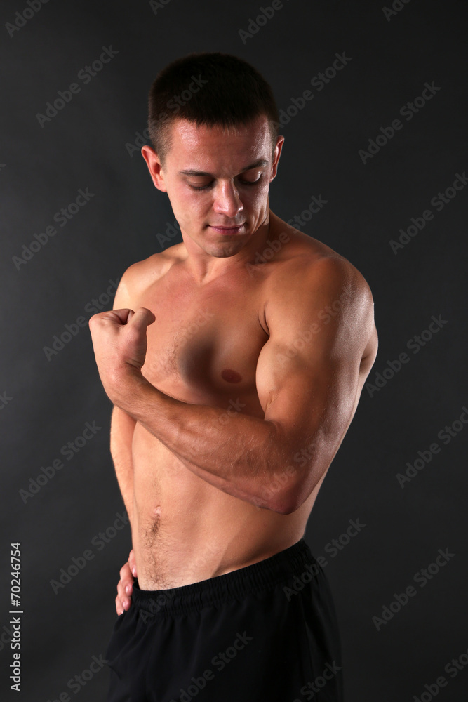 Handsome muscle young man on dark background