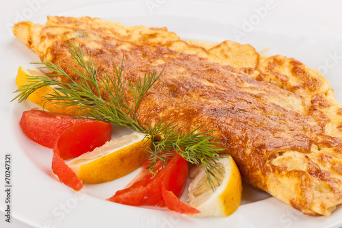 Omelet with herbs, tomatoes and lemon