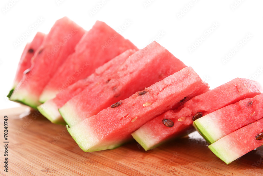 Slices of watermelon on cutting board isolated on white Slices of watermelon on cutting board isolated on white