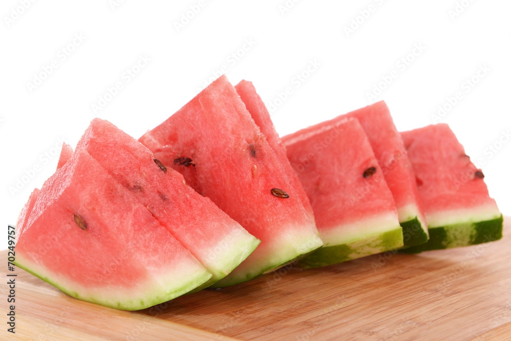 Slices of watermelon on cutting board isolated on white Slices of watermelon on cutting board isolated on white
