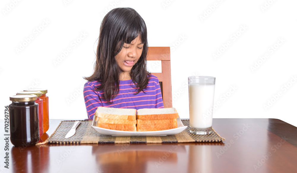 Young Malay Asian preteen girl having breakfast Young Malay Asian preteen girl having breakfast