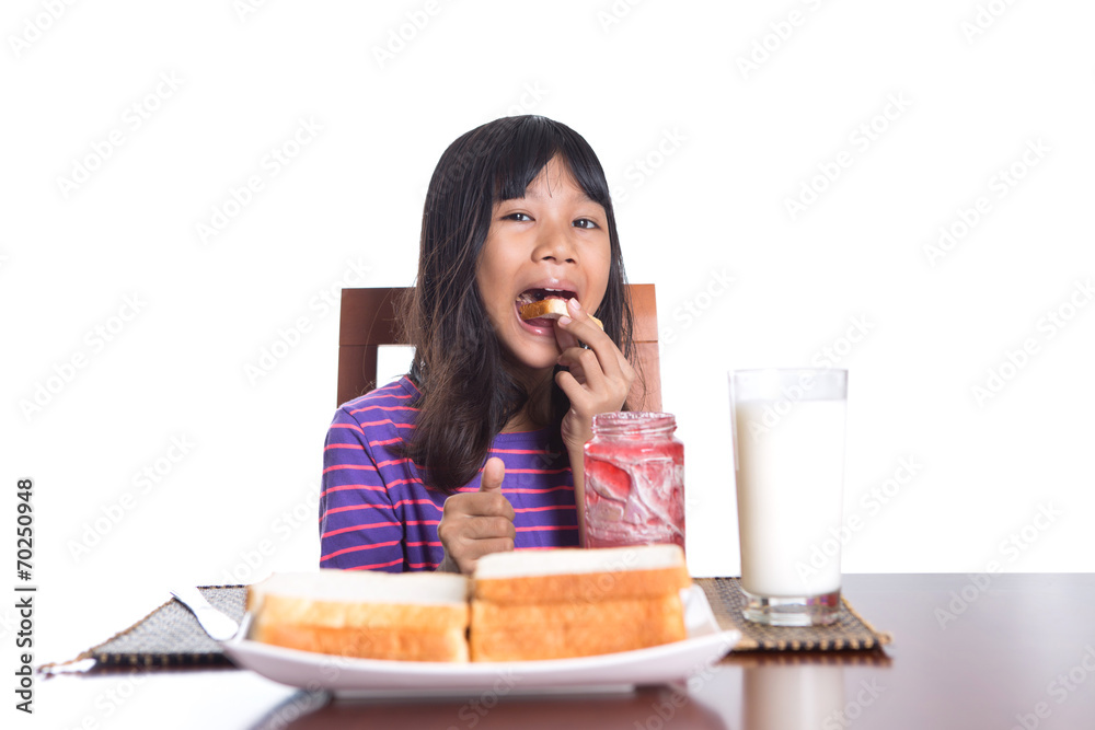 Young Malay Asian preteen girl having breakfast Young Malay Asian preteen girl having breakfast