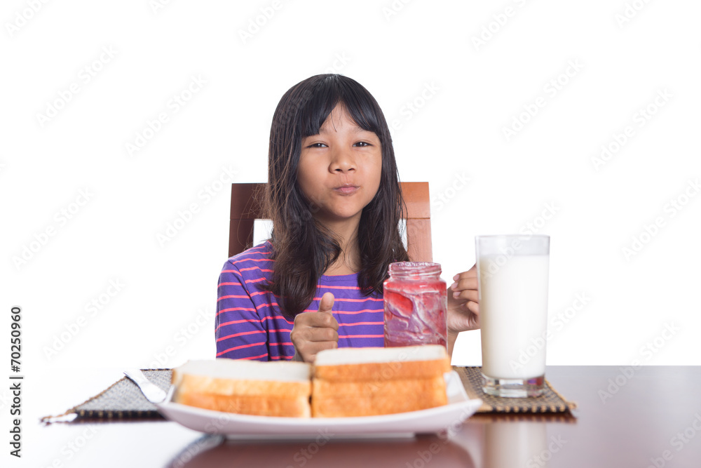 Young Malay Asian preteen girl having breakfast Young Malay Asian preteen girl having breakfast