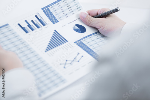 Businessman analyzing investment charts with laptop. Accounting