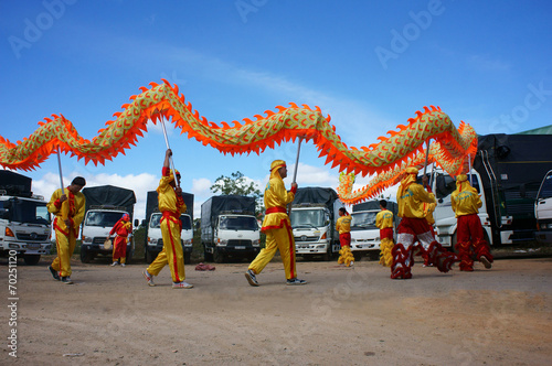 Team of people perform dragon dance photo