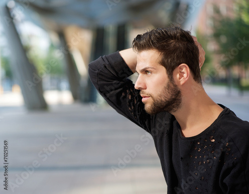 Male fashion model posing with hand in hair