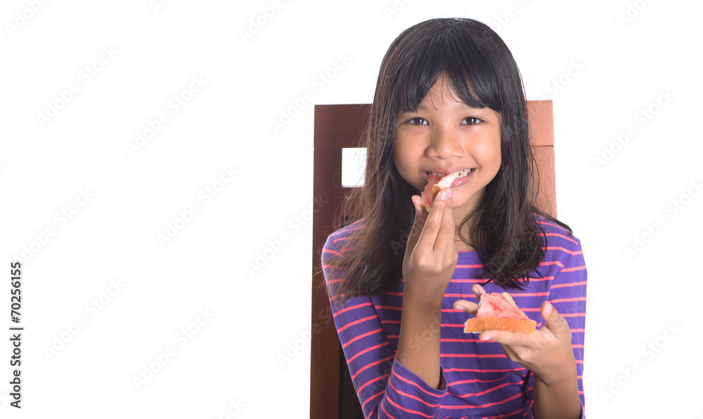 Young Malay Asian preteen girl having breakfast Young Malay Asian preteen girl having breakfast