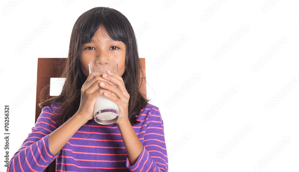 Young Asian preteen girl with a glass of milk Young Asian preteen girl with a glass of milk