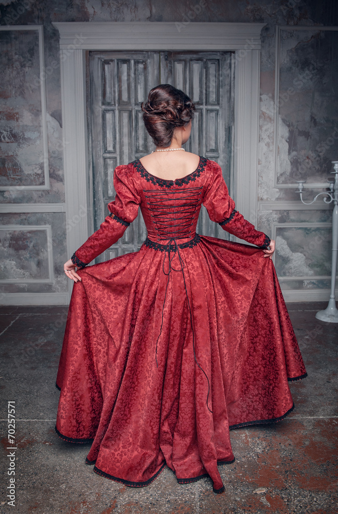 Beautiful medieval woman in red dress, back Beautiful medieval woman in red dress, back
