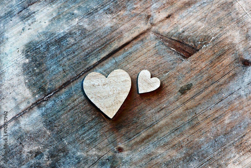 Obraz premium Two Wooden Hearts on Wooden Background