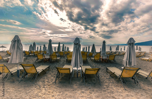 lounge sun bed and umbrella on tropical beach sunrise morning