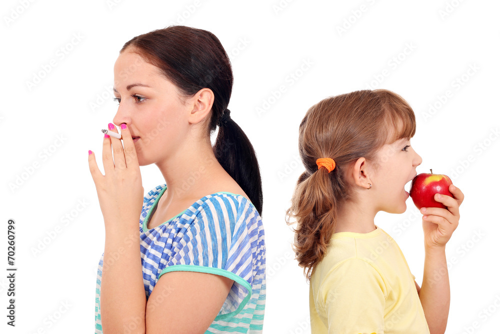 girl smoking a cigarette and little girl eating an apple girl smoking a cigarette and little girl eating an apple