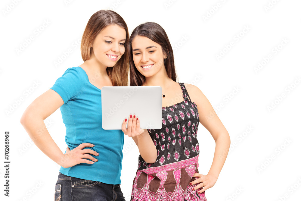 Two teenage girls looking at a tablet