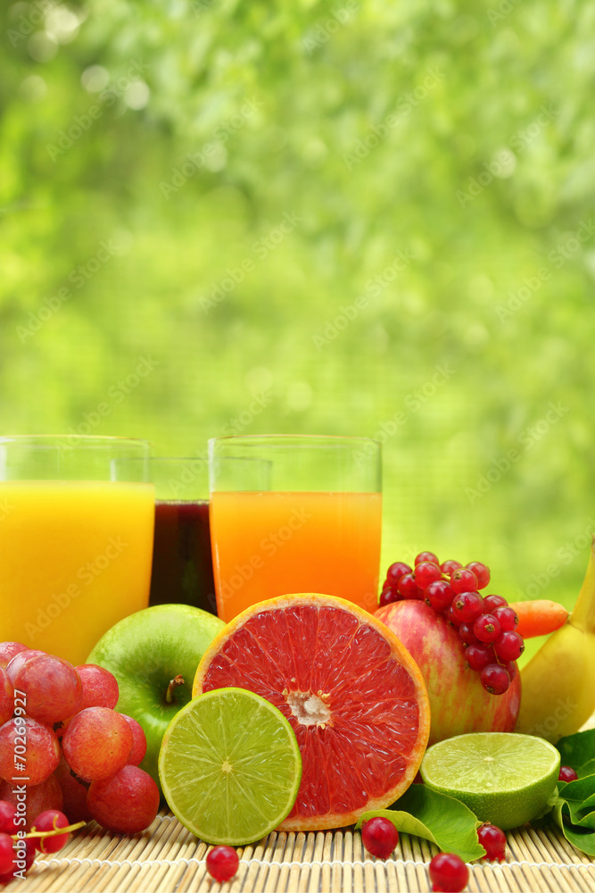 Fresh fruit and three glasses full of juice Fresh fruit and three glasses full of juice