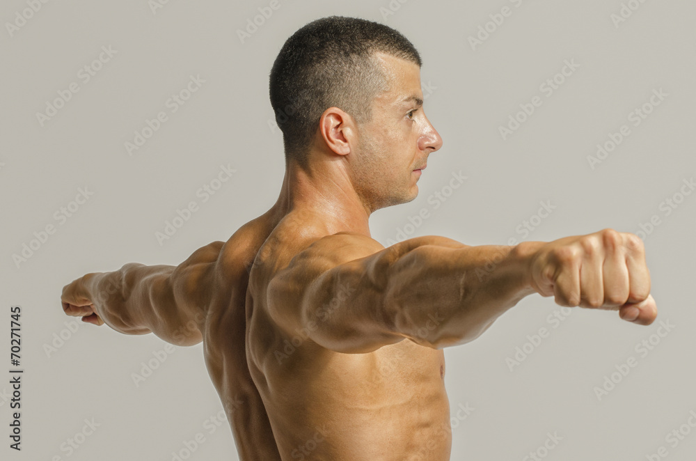 Bodybuilder showing his back,shoulders, triceps and biceps Bodybuilder showing his back,shoulders, triceps and biceps
